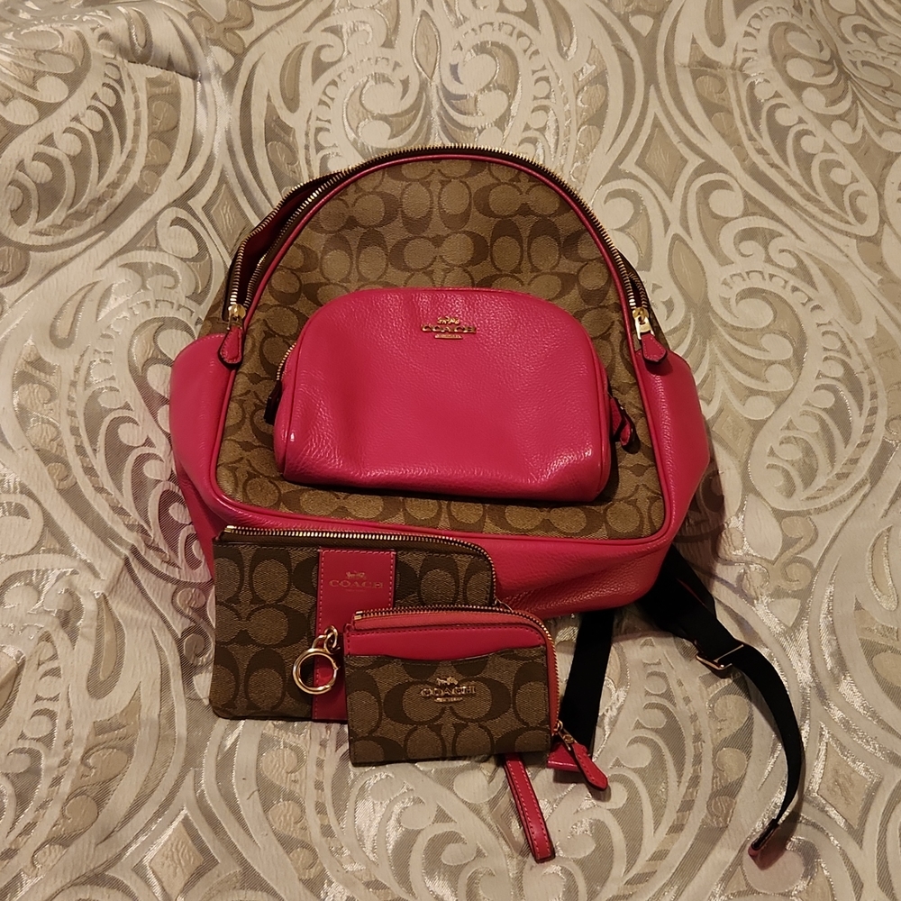Like new pink coach backpack along with wristlet and small wallet